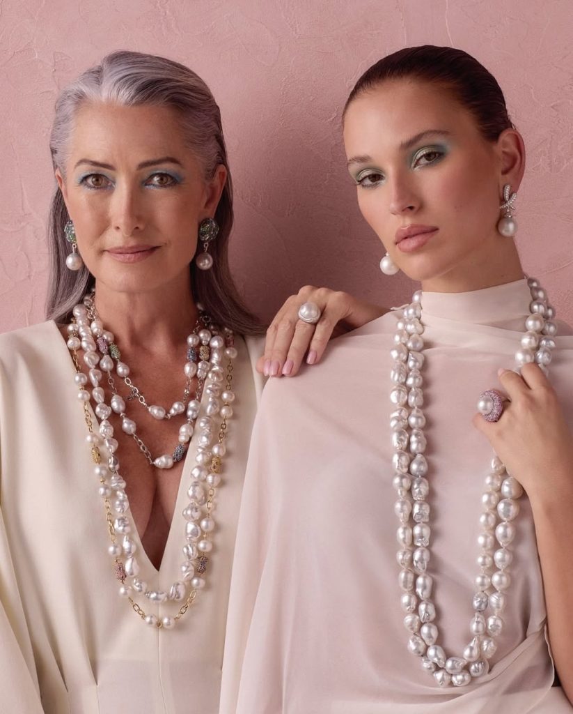 two women wearing baroque pearls necklaces
