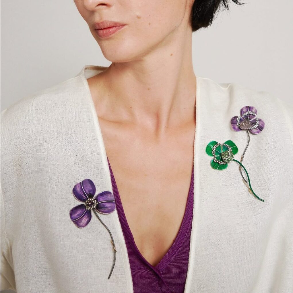 woman wearing brooches