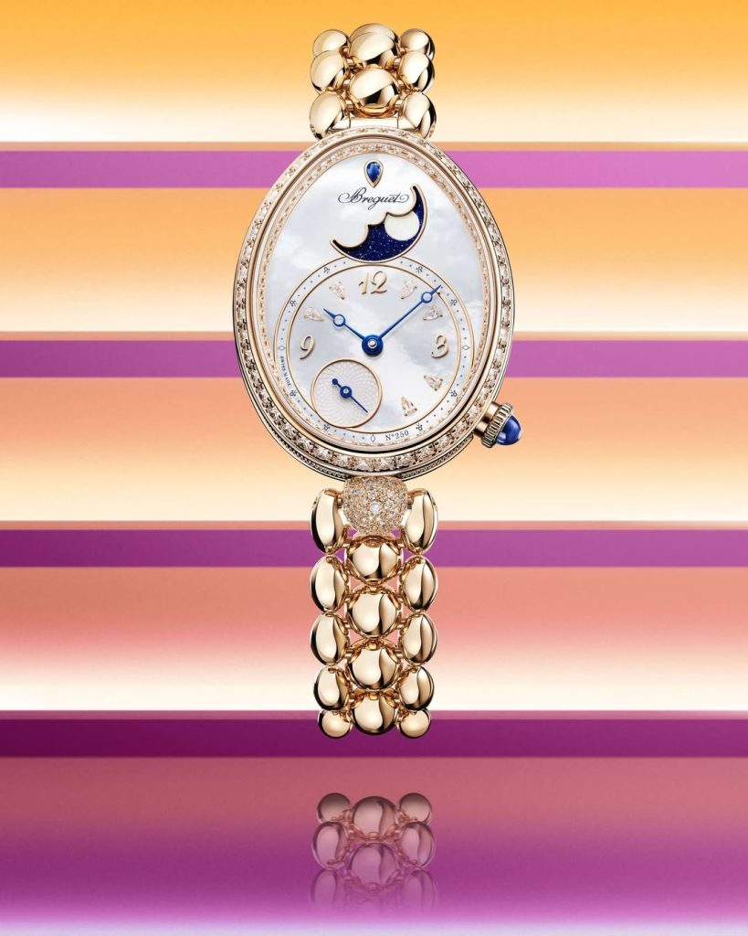 breguet gold wristwatch in colorful background