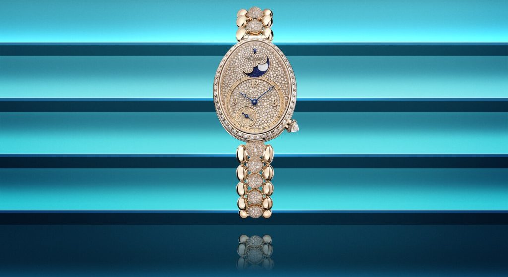 breguet gold watch with snow-set diamonds on blue color background