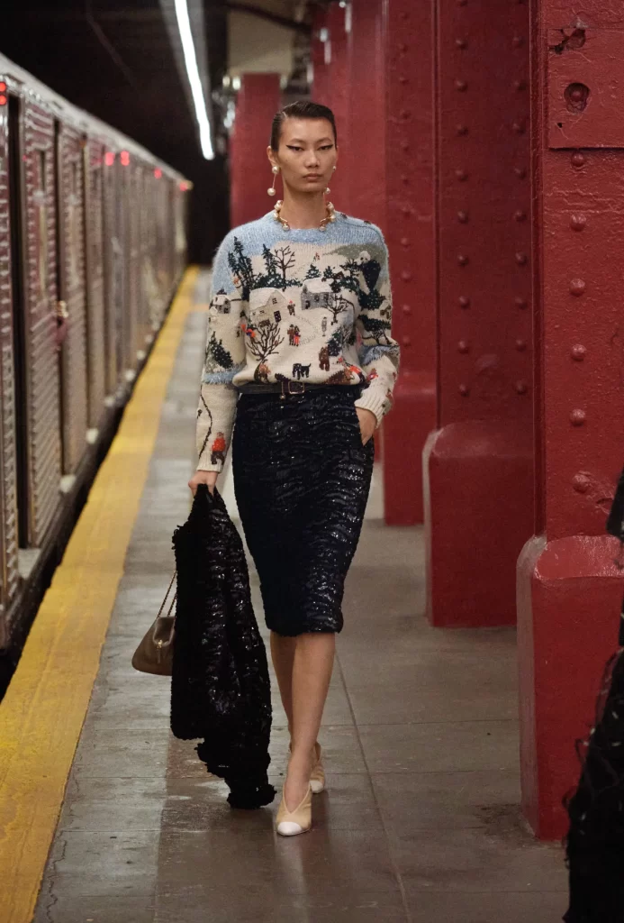 woman wearing chanel gold and pearl choker jewelry at the 2026 métiers d'art show