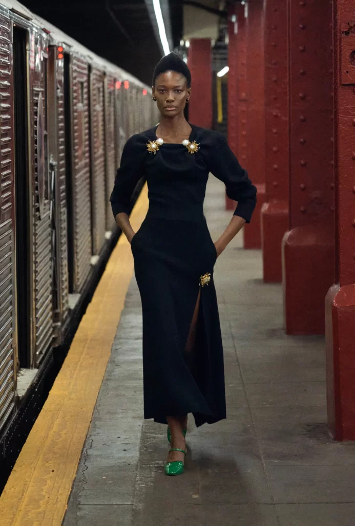 woman wearing chanel gold pearl brooches