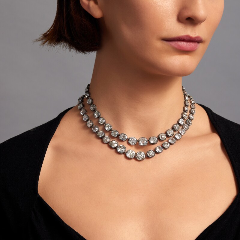 woman wearing two old mine cut diamond necklaces 