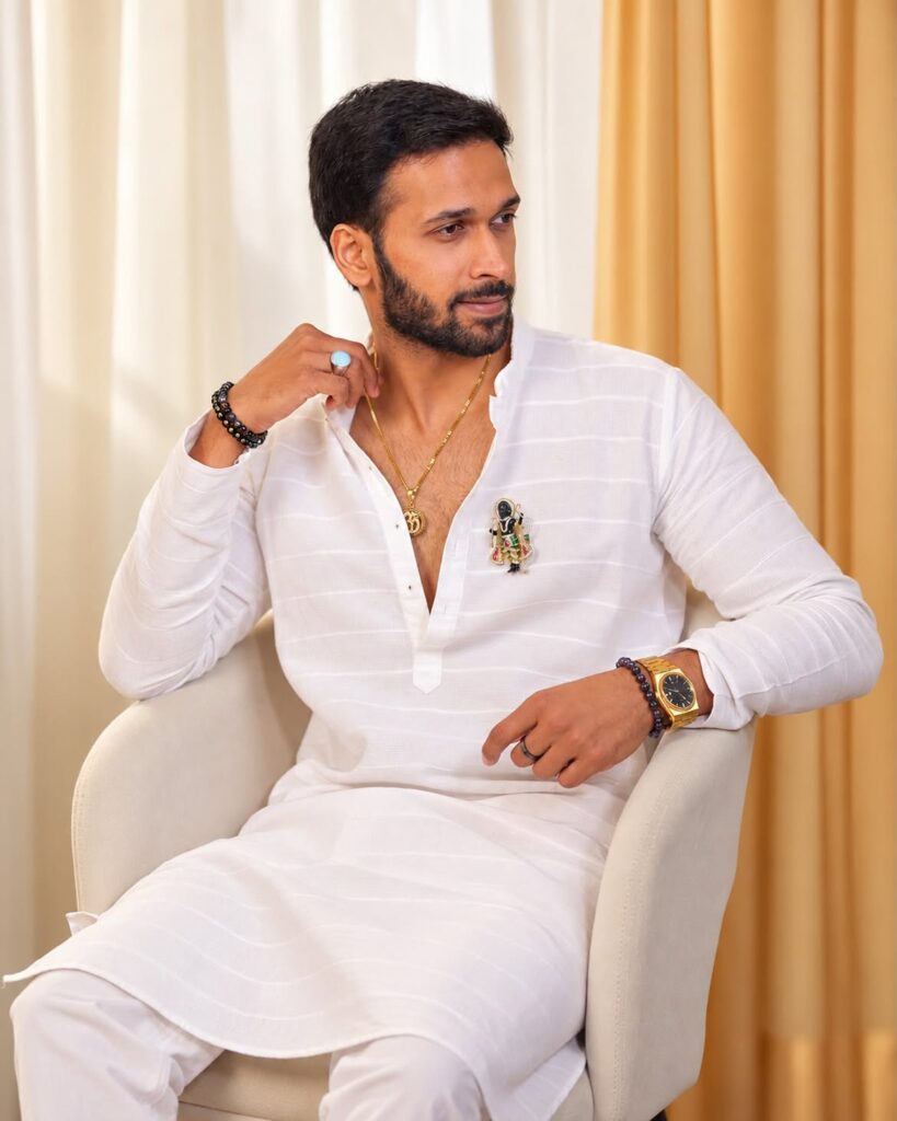 man wearing white outfit and jewelry
