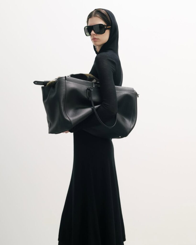 woman carrying black slouchy fendi bag