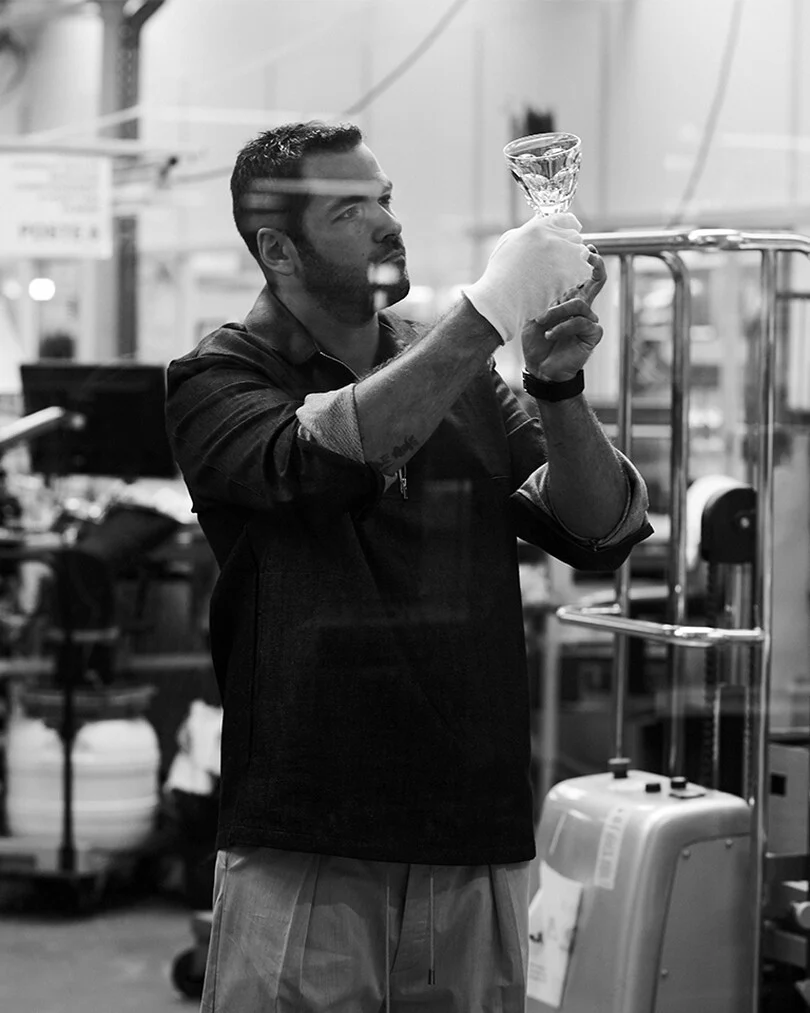 man holding baccarat crystal glass