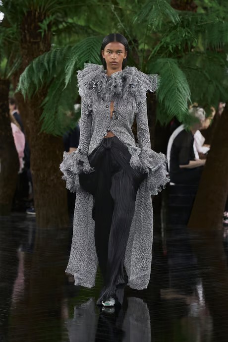 model wears a maxi dress with black pants at dior couture fall winter 2027 show