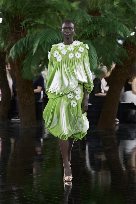 a model wears a green pleated set at dior's couture fall winter 2027 show