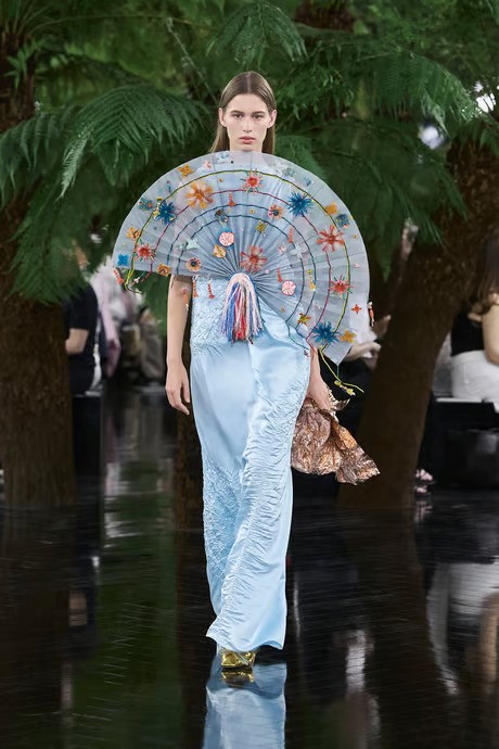 model wears sky blue dior couture dress