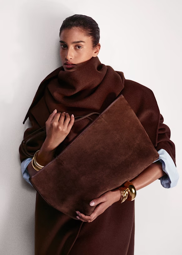 woman carrying brown suede bag for fall